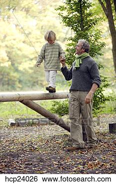 Stock Photo - father helping 
child walk on 
fence. fotosearch 
- search stock 
photos, pictures, 
images, and photo 
clipart
