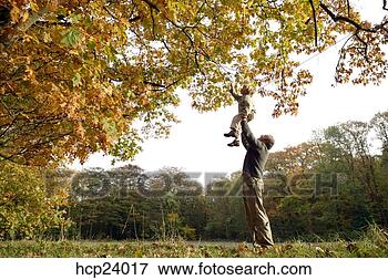 Picture - father lifting 
child up to tree 
branch. fotosearch 
- search stock 
photos, pictures, 
images, and photo 
clipart