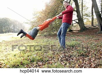 Stock Photo - father swinging 
daughter. fotosearch 
- search stock 
photos, pictures, 
images, and photo 
clipart