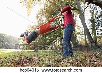 Stock Image - father swinging 
daughter. fotosearch 
- search stock 
photos, pictures, 
images, and photo 
clipart
