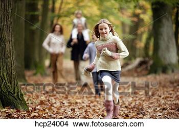 Stock Photo - girl running with 
family in the 
woods. fotosearch 
- search stock 
photos, pictures, 
images, and photo 
clipart