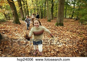 Stock Photo - girl running with 
family in the 
woods. fotosearch 
- search stock 
photos, pictures, 
images, and photo 
clipart