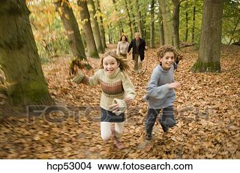 Stock Photo - girl running with 
family in the 
woods. fotosearch 
- search stock 
photos, pictures, 
images, and photo 
clipart
