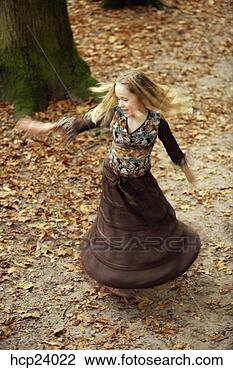 Stock Photo - girl twirling 
skirt in autumn 
leaves. fotosearch 
- search stock 
photos, pictures, 
images, and photo 
clipart
