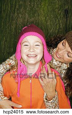 Stock Image - mother and daughter 
in winter hats. 
fotosearch - search 
stock photos, 
pictures, images, 
and photo clipart