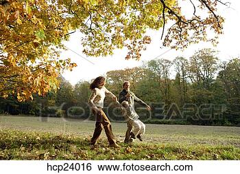 Stock Photo - mother and father 
swinging daughter 
in the woods. 
fotosearch - search 
stock photos, 
pictures, images, 
and photo clipart