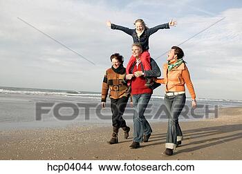 Stock Photo - multi-generation 
family walking 
on beach. fotosearch 
- search stock 
photos, pictures, 
images, and photo 
clipart