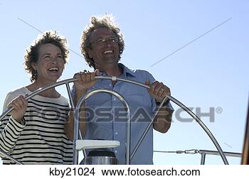 Stock Photo - couple steering 
boat. fotosearch 
- search stock 
photos, pictures, 
images, and photo 
clipart