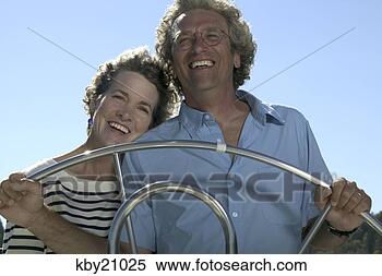 Stock Image - couple steering 
boat. fotosearch 
- search stock 
photos, pictures, 
images, and photo 
clipart