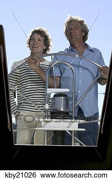 Stock Photo - couple steering 
boat. fotosearch 
- search stock 
photos, pictures, 
images, and photo 
clipart