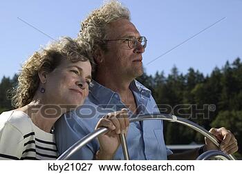 Picture - couple steering 
boat. fotosearch 
- search stock 
photos, pictures, 
images, and photo 
clipart