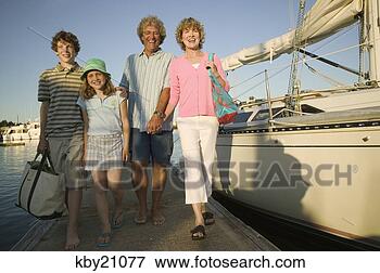 Picture - family leaving 
boat in dock. 
fotosearch - search 
stock photos, 
pictures, images, 
and photo clipart
