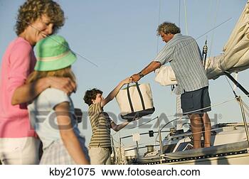 Stock Image - family loading 
up boat. fotosearch 
- search stock 
photos, pictures, 
images, and photo 
clipart