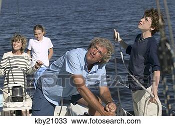 Stock Photo - family manning 
boat. fotosearch 
- search stock 
photos, pictures, 
images, and photo 
clipart