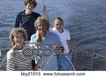 Stock Image - family smiling 
on boat. fotosearch 
- search stock 
photos, pictures, 
images, and photo 
clipart