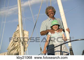 Stock Photo - father and daughter 
standing on boat. 
fotosearch - search 
stock photos, 
pictures, images, 
and photo clipart