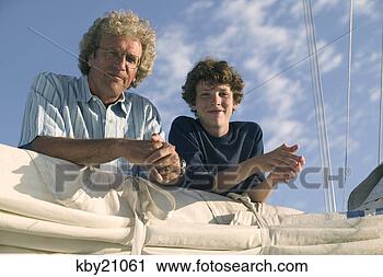 Stock Photography - father and son 
leaning on sail. 
fotosearch - search 
stock photos, 
pictures, images, 
and photo clipart