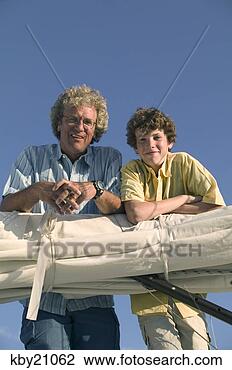 Stock Photo - father and son 
leaning on sail. 
fotosearch - search 
stock photos, 
pictures, images, 
and photo clipart
