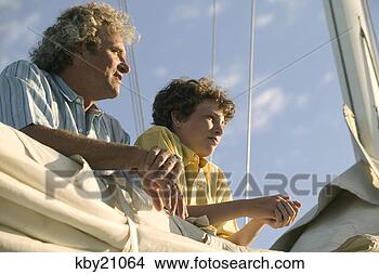 Stock Photo - father and son 
leaning on sail. 
fotosearch - search 
stock photos, 
pictures, images, 
and photo clipart
