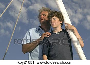 Stock Photography - father and son 
looking out to 
sea. fotosearch 
- search stock 
photos, pictures, 
images, and photo 
clipart