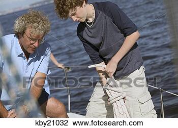 Stock Photo - father and son 
manning boat. 
fotosearch - search 
stock photos, 
pictures, images, 
and photo clipart