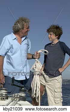 Stock Photograph - father and son 
manning boat. 
fotosearch - search 
stock photos, 
pictures, images, 
and photo clipart