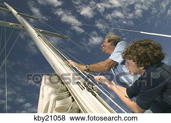 Stock Photo - father and son 
raising sail. 
fotosearch - search 
stock photos, 
pictures, images, 
and photo clipart