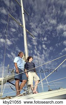 Stock Image - father and son 
standing on boat. 
fotosearch - search 
stock photos, 
pictures, images, 
and photo clipart