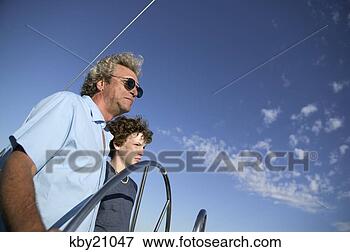 Picture - father and son 
steering boat. 
fotosearch - search 
stock photos, 
pictures, images, 
and photo clipart