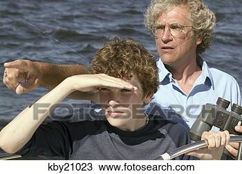 Stock Photo - father teaching 
son to steer boat. 
fotosearch - search 
stock photos, 
pictures, images, 
and photo clipart