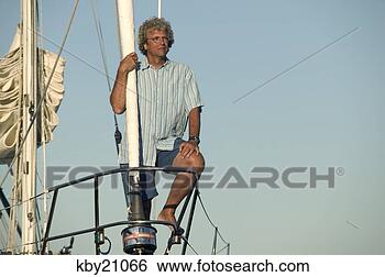 Stock Photo - man looking out 
over to from boat. 
fotosearch - search 
stock photos, 
pictures, images, 
and photo clipart
