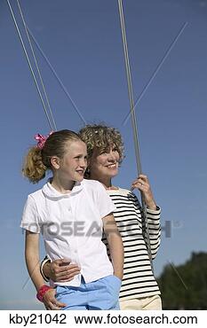 Stock Photo - mother and daughter 
standing on boat. 
fotosearch - search 
stock photos, 
pictures, images, 
and photo clipart