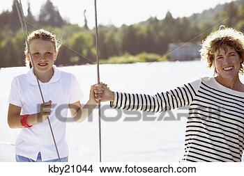 Stock Photo - mother and daughter 
standing on boat. 
fotosearch - search 
stock photos, 
pictures, images, 
and photo clipart