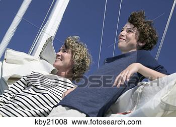 Stock Photo - mother and son 
relaxing on sail. 
fotosearch - search 
stock photos, 
pictures, images, 
and photo clipart