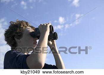 Stock Photograph - teenage boy using 
binoculars. fotosearch 
- search stock 
photos, pictures, 
images, and photo 
clipart
