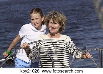 Stock Photo - woman steering 
boat. fotosearch 
- search stock 
photos, pictures, 
images, and photo 
clipart