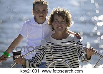 Stock Photography - woman steering 
boat. fotosearch 
- search stock 
photos, pictures, 
images, and photo 
clipart