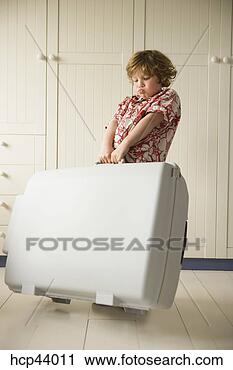 Stock Photography - boy lugging heavy 
suitcase. fotosearch 
- search stock 
photos, pictures, 
images, and photo 
clipart