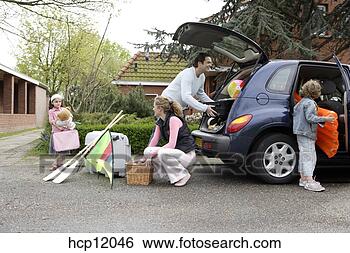 Stock Photo - family packing 
car. fotosearch 
- search stock 
photos, pictures, 
images, and photo 
clipart