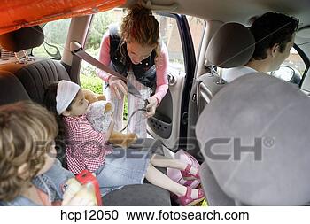Stock Photography - mother strapping 
daughter into 
backseat. fotosearch 
- search stock 
photos, pictures, 
images, and photo 
clipart