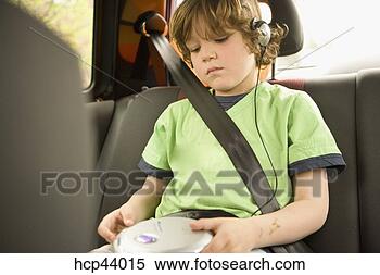 Stock Image - young boy listening 
to headphones 
in backseat. fotosearch 
- search stock 
photos, pictures, 
images, and photo 
clipart