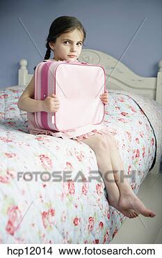 Stock Photo - young girl holding 
suitcase on bed. 
fotosearch - search 
stock photos, 
pictures, images, 
and photo clipart