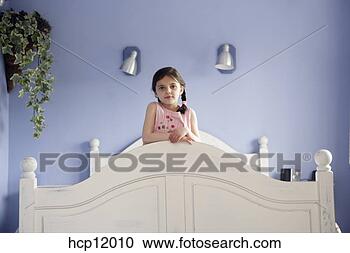 Stock Photography - young girl standing 
on bed. fotosearch 
- search stock 
photos, pictures, 
images, and photo 
clipart