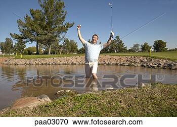Stock Photography - cheering male 
golfer in lake. 
fotosearch - search 
stock photos, 
pictures, images, 
and photo clipart