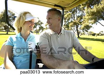 Stock Photo - couple driving 
golf cart. fotosearch 
- search stock 
photos, pictures, 
images, and photo 
clipart