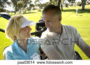 Stock Photo - couple driving 
golf cart. fotosearch 
- search stock 
photos, pictures, 
images, and photo 
clipart