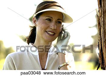 Stock Photo - female golfer 
talking on cell 
phone. fotosearch 
- search stock 
photos, pictures, 
images, and photo 
clipart