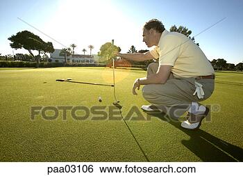 Stock Photo - male golfer lining 
up shot. fotosearch 
- search stock 
photos, pictures, 
images, and photo 
clipart