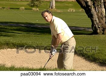 Stock Photo - man hitting golf 
ball out of bunker. 
fotosearch - search 
stock photos, 
pictures, images, 
and photo clipart