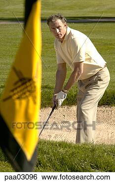 Stock Photo - man hitting golf 
ball out of bunker. 
fotosearch - search 
stock photos, 
pictures, images, 
and photo clipart
